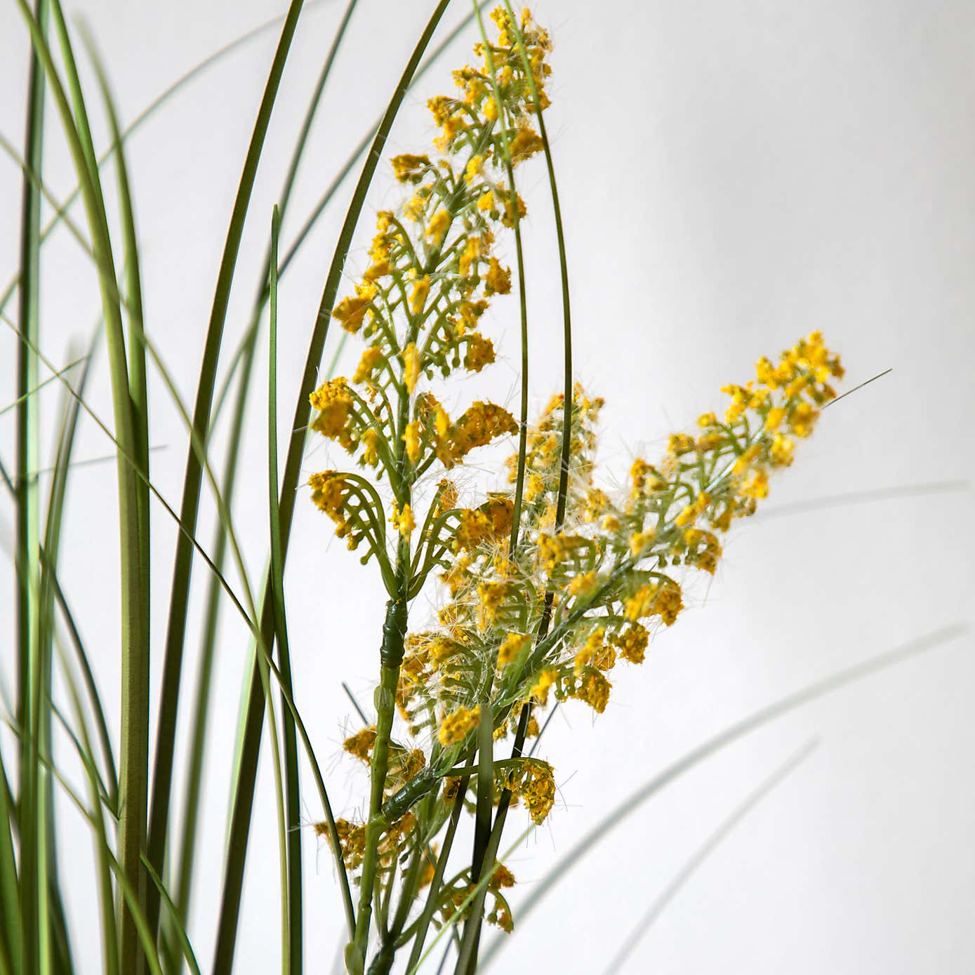 Artificial Grass with Yellow Wildflower in Black Plant Pot